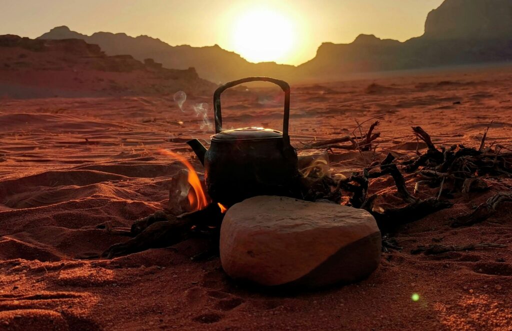 Kettle on Top of a Bonfire in an Open F